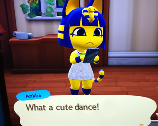 anthro blue_hair clothing dialogue dress fake_screencap female fur hair holding_object holding_phone humor inside looking_at_object looking_at_phone phone solo white_clothing white_dress yellow_body yellow_fur cartuniverse animal_crossing nintendo ankha_(animal_crossing) domestic_cat felid feline felis mammal