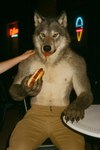 anthro blurred_background bottomwear chair clothed clothing eating food fur furniture grey_body grey_fur hand_on_shoulder hot_dog looking_at_viewer male nipples on_chair outside pants partially_clothed photorealism photorealistic realistic realistic_fur realistic_lighting shirtless sitting sitting_on_chair solo table yellow_eyes delken canid canine canis mammal wolf hi_res